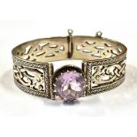 A SCOTTISH SILVER AMETHYST SET BANGLE The celtic design bangle with large round cut amethyst to