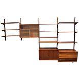 POUL CADOVIUS: A DANISH ROSEWOOD 'SYSTEM CADO' SUITE OF WALL MOUNTED FURNITURE comprising: six