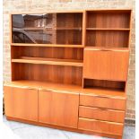 A H MCINTOSH OF KIRKCALDY: a teak wall unit, the upper section with sliding glazed doors, shelves