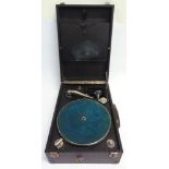 A PORTABLE GRAMOPHONE with a Songster Superb reproducer, and a black rexine covered case.