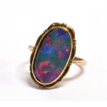 A 19th CENTURY OPAL DOUBLET SIGNET RING The oval black opal doublet 13mm x 7mm, bezel set, the