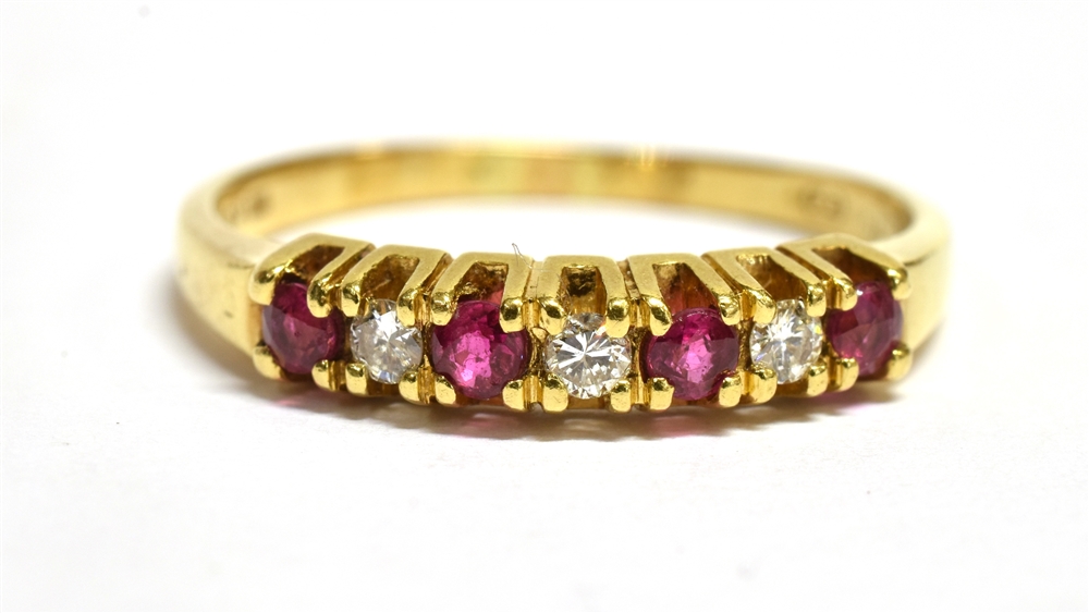 A MODERN RUBY AND DIAMOND SEVEN STONE RING Four small round cut rubies and three small cut