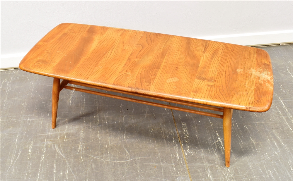 A LIGHT ERCOL COFFEE TABLE with magazine rack undertier, the rectangular top 105cm x 44cm