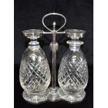 STYLE OF CHRISTOPHER DRESSER: A Hukin & Heath two bottle Tantalus with silver plated frame,