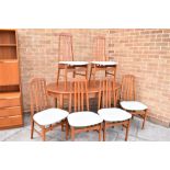 A G-PLAN STYLE EXTENDING OVAL DINING TABLE and matching set on six chairs, the table 153cm long (