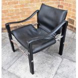 MAURICE BURKE FOR ARKANA: a chromed steel and ebonised framed 'Safari' armchair, with black vinyl