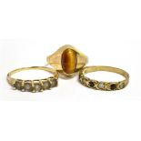 THREE 9CT GOLD STONE SET RINGS Comprising a tigers eye, size M 1/2; and two stone set half hoop