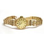 A LADIES 9CT GOLD TISSOT WATCH on a 9ct gold bracelet small round dial and head 18 mm case size,