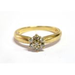 A DIAMOND FLOWERHEAD CLUSTER 9 CARAT GOLD RING comprising seven round brilliant cut