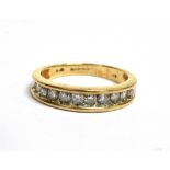 A DIAMOND HALF ETERNITY 9CT GOLD RING a total of eleven round brilliant cut diamonds, a total