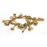 A 9CT GOLD BRACELET WITH THIRTEEN SMALL GOLD CHARMS And one silver charm, the thirteen charms