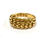 A GENT'S 18CT YELLOW GOLD KEEPER RING The interwoven front to hallmarked 18ct yellow gold shank,