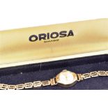 A LADIES VINTAGE ORIOSA 9CT GOLD BRACELET WATCH The small round steel dial to 9ct gold case and