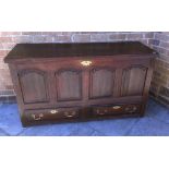 AN OAK MULE CHEST with hinged top and fitted candle box interior, with two drawers to the base, 81cm