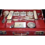 A CARTIER ART DECO SILVER AND GLASS NEAR COMPLETE TRAVELLING DRESS SET The red leather case marked