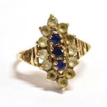 A 9CT GOLD BLUE AND WHITE STONE SET DRESS RING the fancy oval cluster to grooved shoulders and 9ct