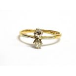 A DIAMOND TWO STONE 18CT GOLD RING the vertical set with small round brilliant cut diamonds,