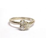 A DIAMOND THREE STONE 18CT WHITE GOLD RING A triangle of three round brilliant cut diamonds with a