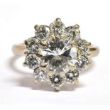 A 1.5 CARAT DIAMOND CENTRE STONE CLUSTER RING the central round old brilliant cut diamond weighing