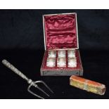 A SILVER HANDLED TOASTING FORK Together with a set of six white metal napkin rings, unmarked, boxed;
