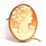 A 9CT GOLD CAMEO BROOCH The oval shell cameo 5 cms X 4 cms, applied pad to mount stamped 9ct,