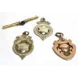 A 9CT GOLD BAR BROOCH AND THREE SILVER SHIELD FOBS the bar brooch with metal pin, gross weight