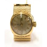 A LADIES VINTAGE OMEGA 9CT GOLD BRACELET WATCH Small round dial to 9ct gold case and integral