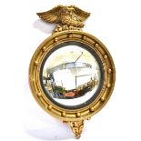 ATSONEA CONVEX WALL MIRROR, with eagle surmount and with a ball and cavetto surround, makers sign