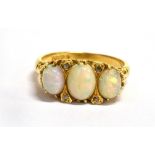 A THREE STONE OPAL 18CT GOLD RING the three oval cabochon cut opals with small diamond points