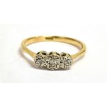 A DIAMOND THREE STONE ILLUSION SET 18CT GOLD RING Three small round old cut diamonds, 18ct yellow