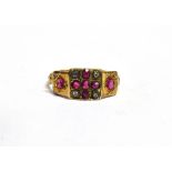 A LATE VICTORIAN RUBY AND DIAMOND 18CT GOLD RING The square head with a cross of diamonds between
