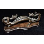 A CHINESE BRONZE GROUP modelled as two conjoined dragons, 18cm wide, on hardwood stand Condition