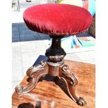 AN ADJUSTABLE PIANO STOOL, with red upholstered seat, 53cm high