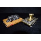 A VICTORIAN BRASS MOUNTED DESK BLOTTER 17cm wide, and a composition paperweight in the form of a dog