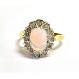 AN OPAL AND DIAMOND CLUSTER 18CT GOLD RING the oval cluster comprising a centre cabochon cut opal, 9