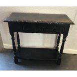 A CARVED OAK SIDE TABLE, with single frieze drawer above a stretcher shelf, 77cm x 84cm x 48cm