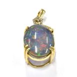 A 9CT GOLD OPAL DOUBLET PENDANT The oval doublet 17mm x 10mm with white stones to bale, 3cms long,