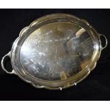 AN OVAL TWO HANDLED SILVER TRAY of plain form with raised scroll border to each end, hallmarked