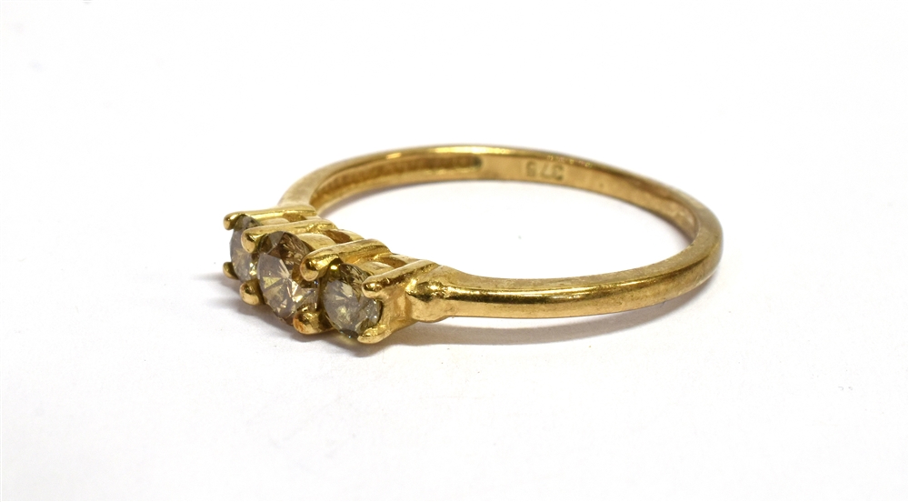 A CHAMPAGNE DIAMOND THREE STONE 9CT GOLD RING The three champagne coloured diamonds weighing a total - Image 3 of 3