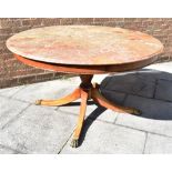 CIRCULAR MAHOGANY TABLE, with marble top and raised on central column with three legs with brass