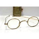A SILVER VESTA CASE Together with a pair of 19th Century yellow metal spectacles (unmarked).