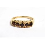 A 9CT GOLD GARNET SET DRESS RING Five small round cut garnets, size N, gross weight approx. 2.3