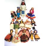 FOURTEEN ASSORTED CLOTH, COMPOSITION & PLASTIC DOLLS each in national costume, the largest 27cm