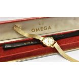 A LADIES VINTAGE 18CT GOLD WRIST WATCH on a non-Omega 9ct gold bracelet, round steel dial with