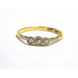 A DIAMOND THREE STONE 18CT GOLD RING three illusion set diamonds platinum set to a 18ct yellow