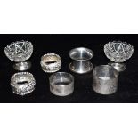 FIVE ASSORTED SILVER NAPKIN RINGS Weighing a total of approx. 96.4 grams; together with a pair of