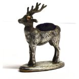 A MINIATURE SILVER STAG PIN CUSHION the miniature model of a stag on an oval base, hallmarked