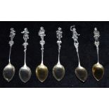 A SET OF SIX SILVER TEASPOONS BY BERTHOLD MULLER Each finical with a different figure playing a