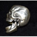 A SILVER SKULL VESTA CASE The late 20th century skull stamped 925 inside hinged opening jaw 5cms,