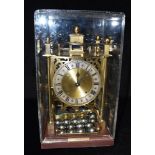 A HARDING & BAZELEY SPHERICAL WEIGHT CLOCK with twenty-four steel balls and perspex cover, 37cm high